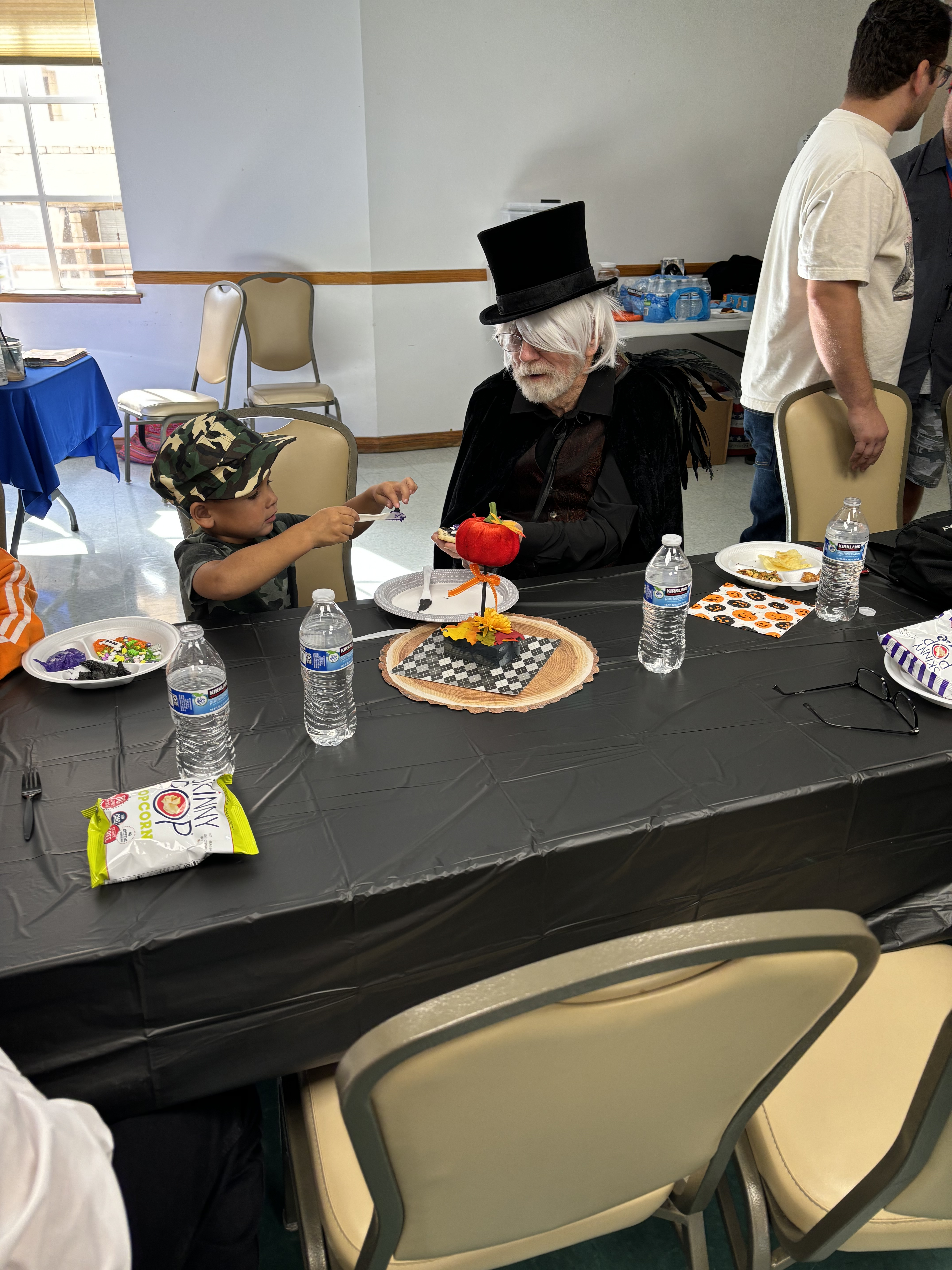 Roger and a preschool tyke decorating a cookie